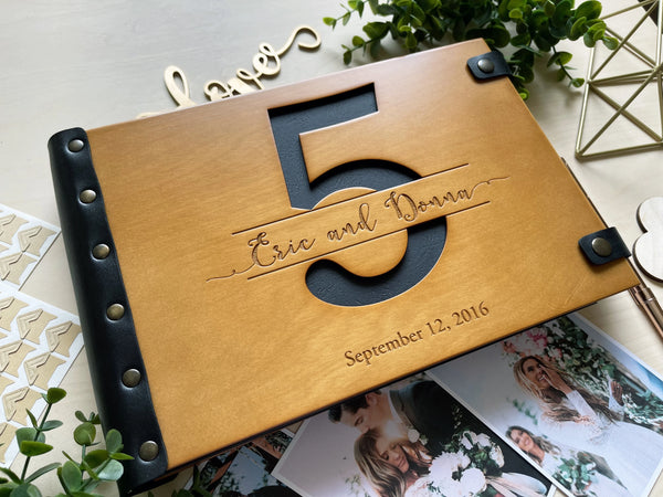 fifth anniversary photo album with cut out number 5 and black first page