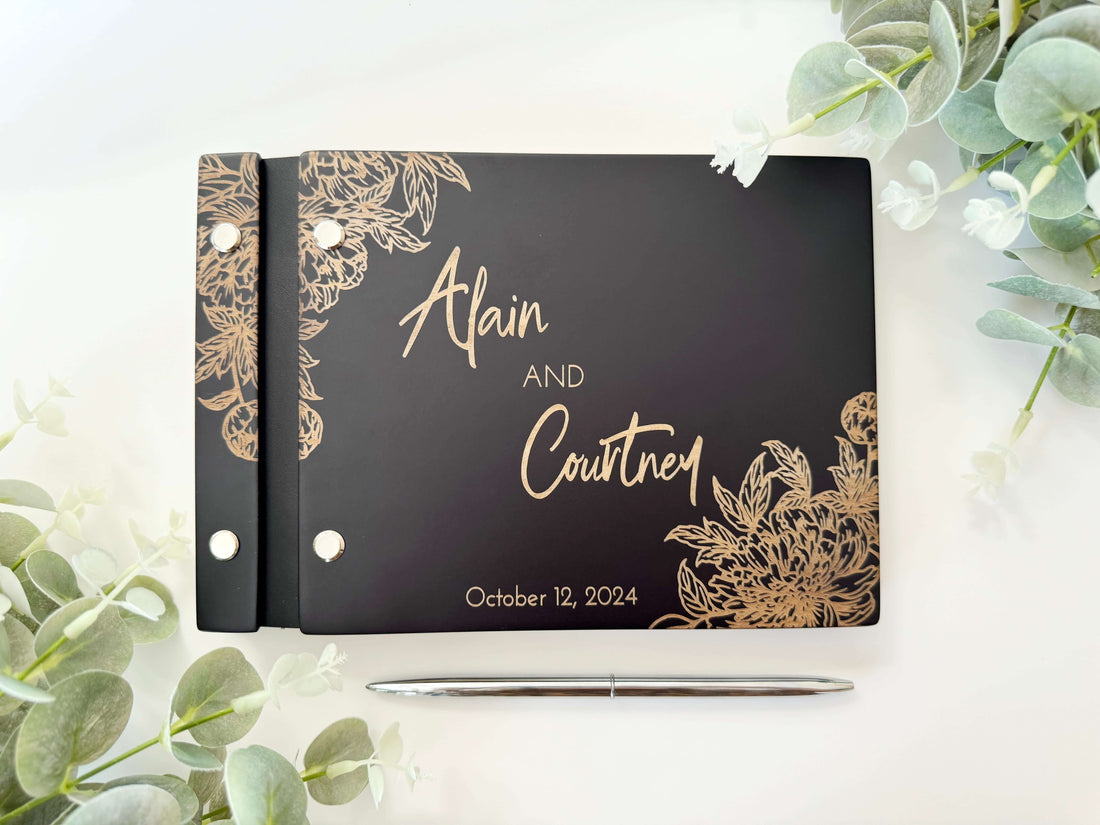 Black floral engraved wooden wedding guest book with personalized names — elegant black wedding album