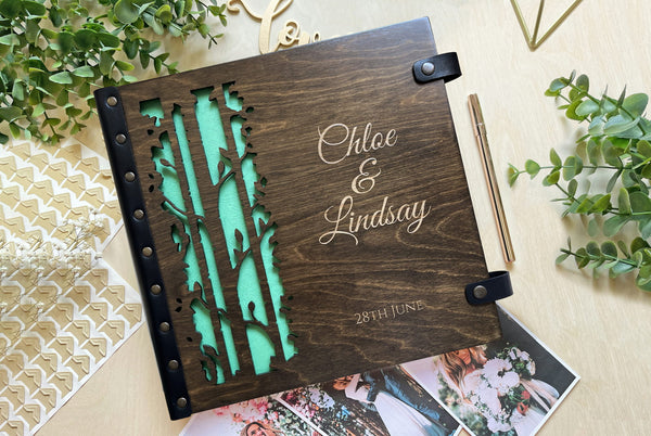 Personalized wooden wedding album with laser-cut tree design
