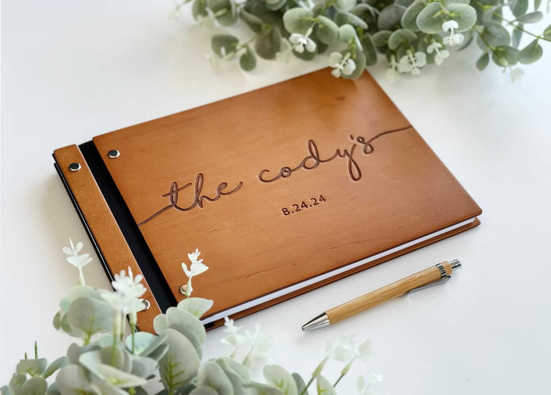 Wooden engraved guest book cover in oak with custom name design