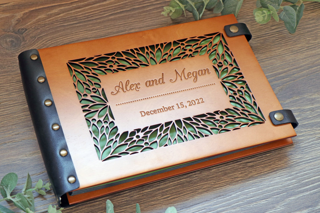 Personalized wooden wedding album with laser-cut floral frame