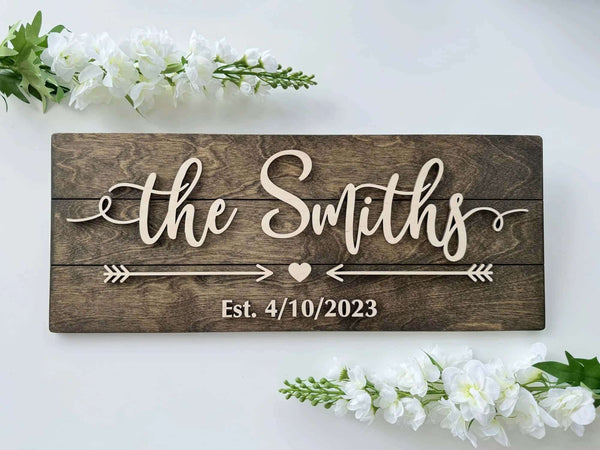 Personalized wooden family name sign with natural raised letters, arrows and heart, Est