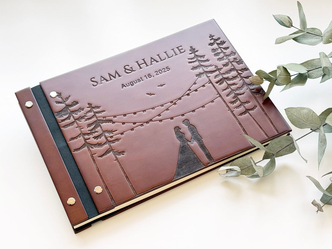 Rustic forest wedding guest book with engraved couple and mountain design