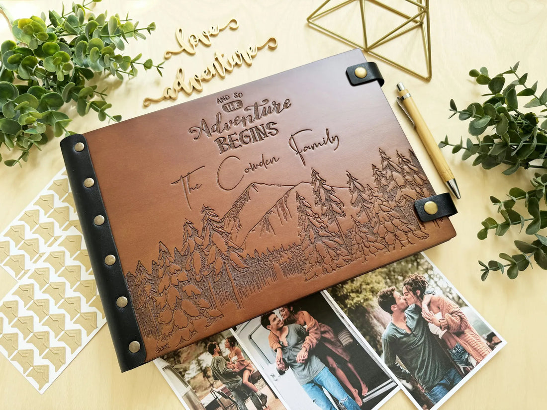 Personalized wooden photo album with engraved mountains and text And So The Adventure Begins for The Cowden Family.