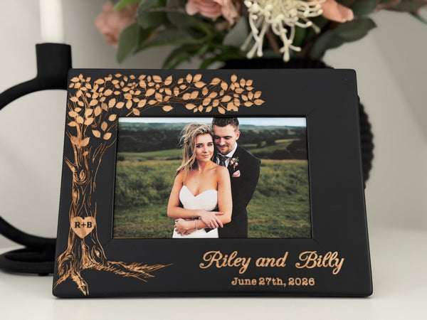 Black wedding picture frame with engraved tree and initials in a heart