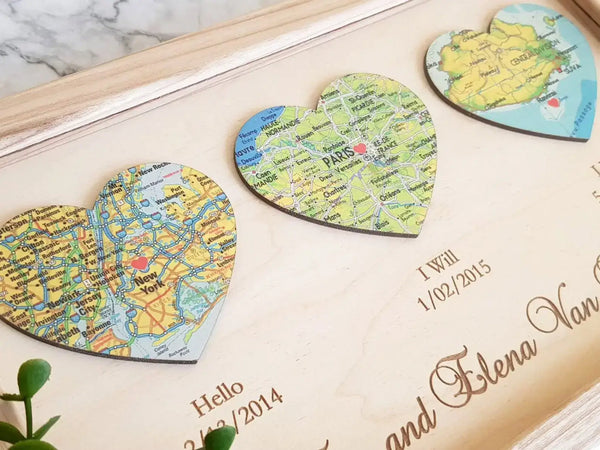 Close up detail of vintage map inside a heart shape cutout on a wooden background for anniversary gift.