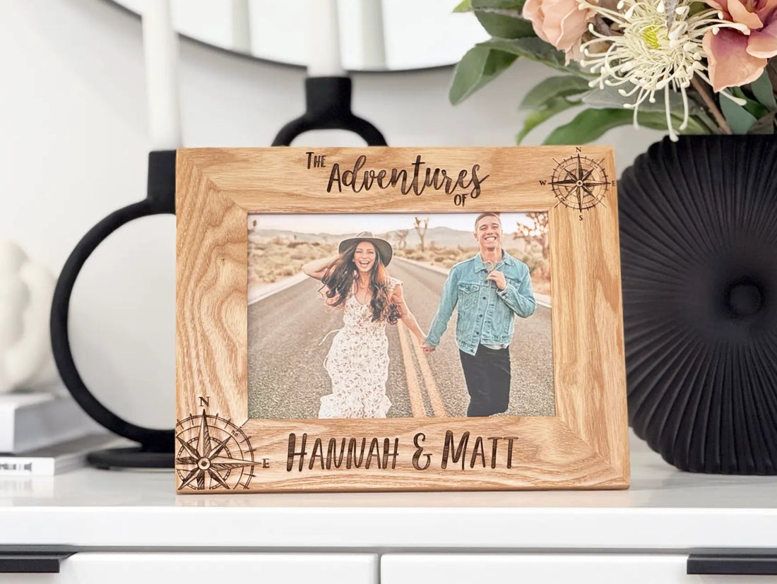 Personalized adventure picture frame with engraved compass roses and names in oak
