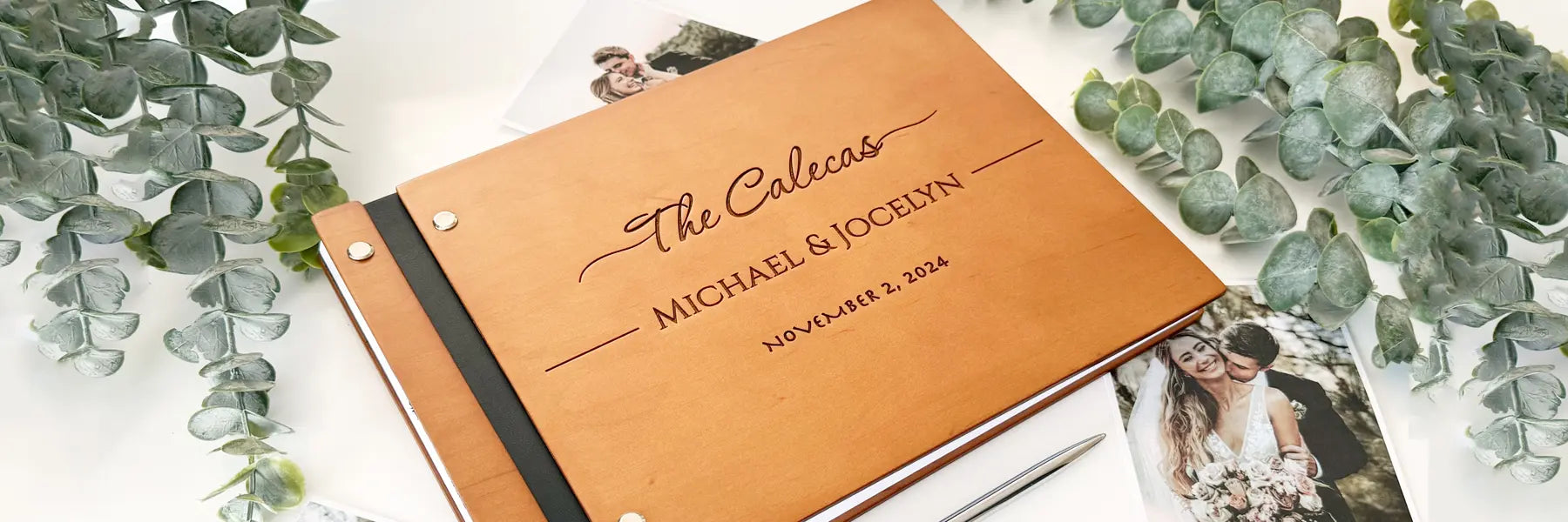 Personalized wooden wedding guest book with custom laser engraving and leather binding, displayed with eucalyptus greenery and wedding photos.