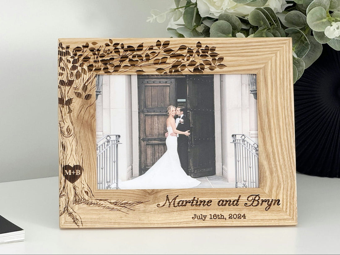 Personalized wooden wedding photo frame in oak with engraved tree and initials in a heart