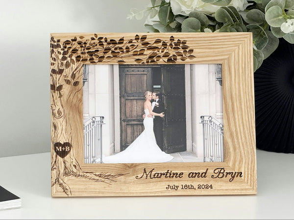 Personalized wooden wedding photo frame in oak with engraved tree and initials in a heart