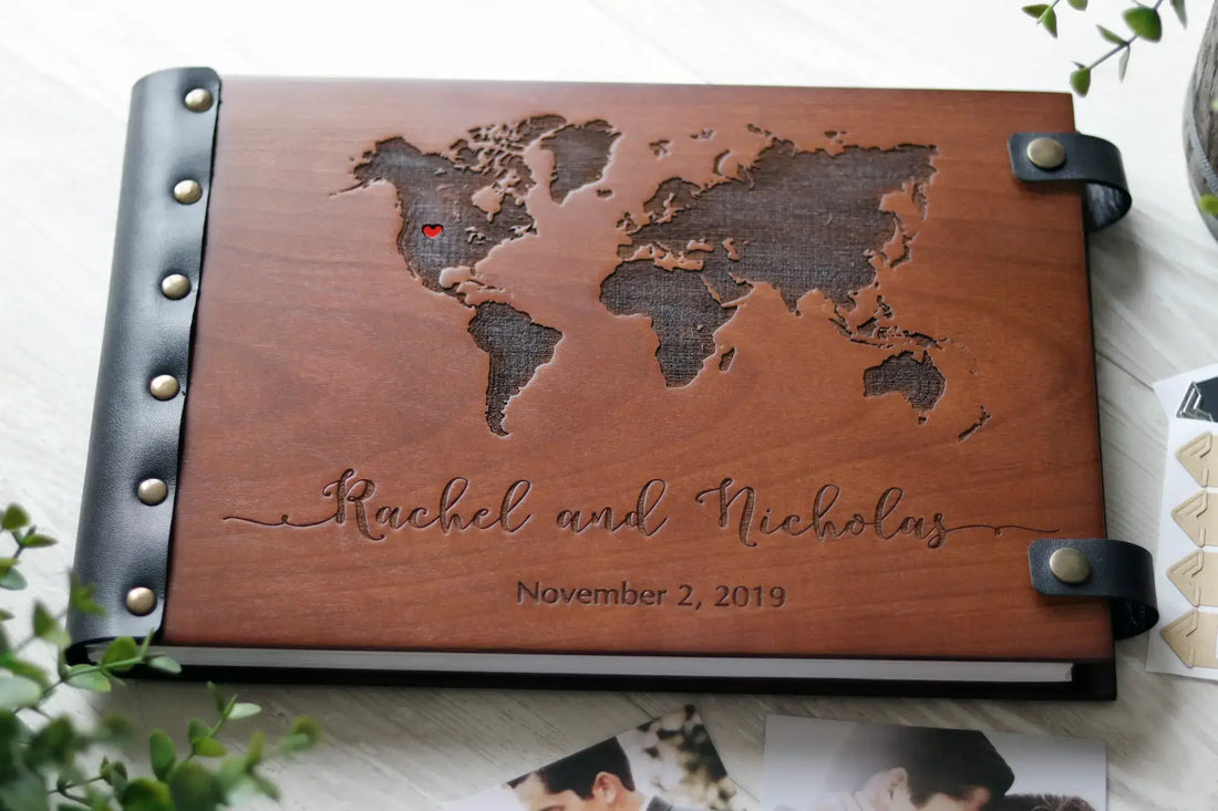 Personalized wooden photo album with laser engraved world map and names Rachel and Nicholas.