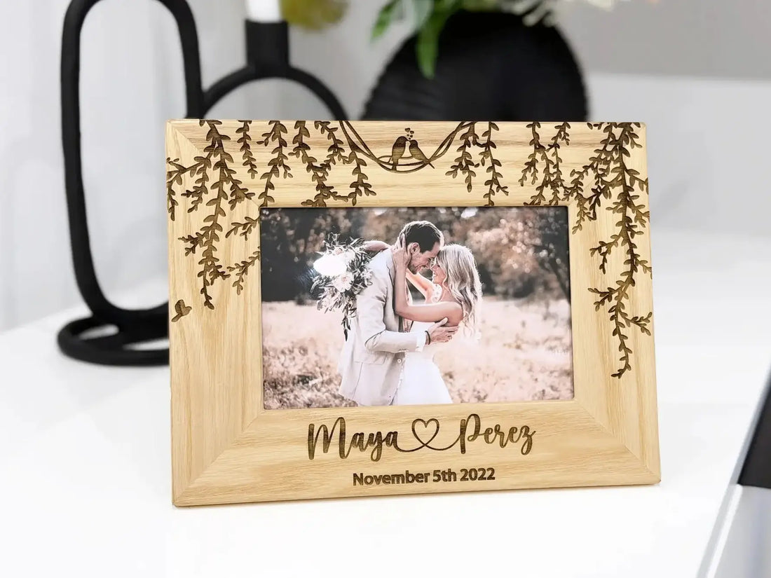 Solid wood picture frame with nature design displayed on a white shelf.