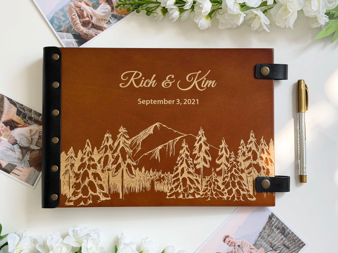 snowy mountain photo album engraved with snow capped peak and pine forest